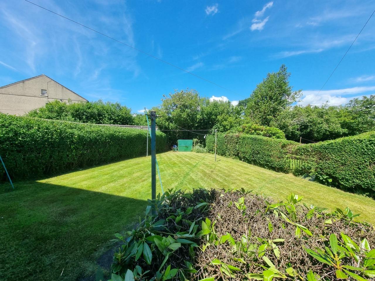 Finished rear lawn and hedge line after HedgeBros garden restoration in Partick West End